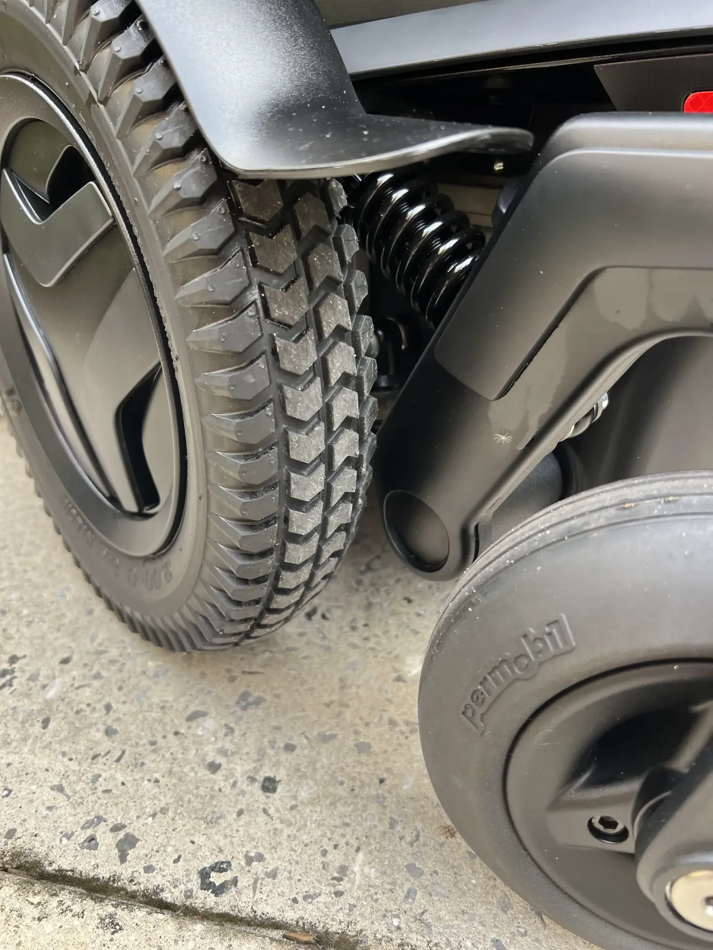 Permobil M3 Corpus wheel and suspension close-up
