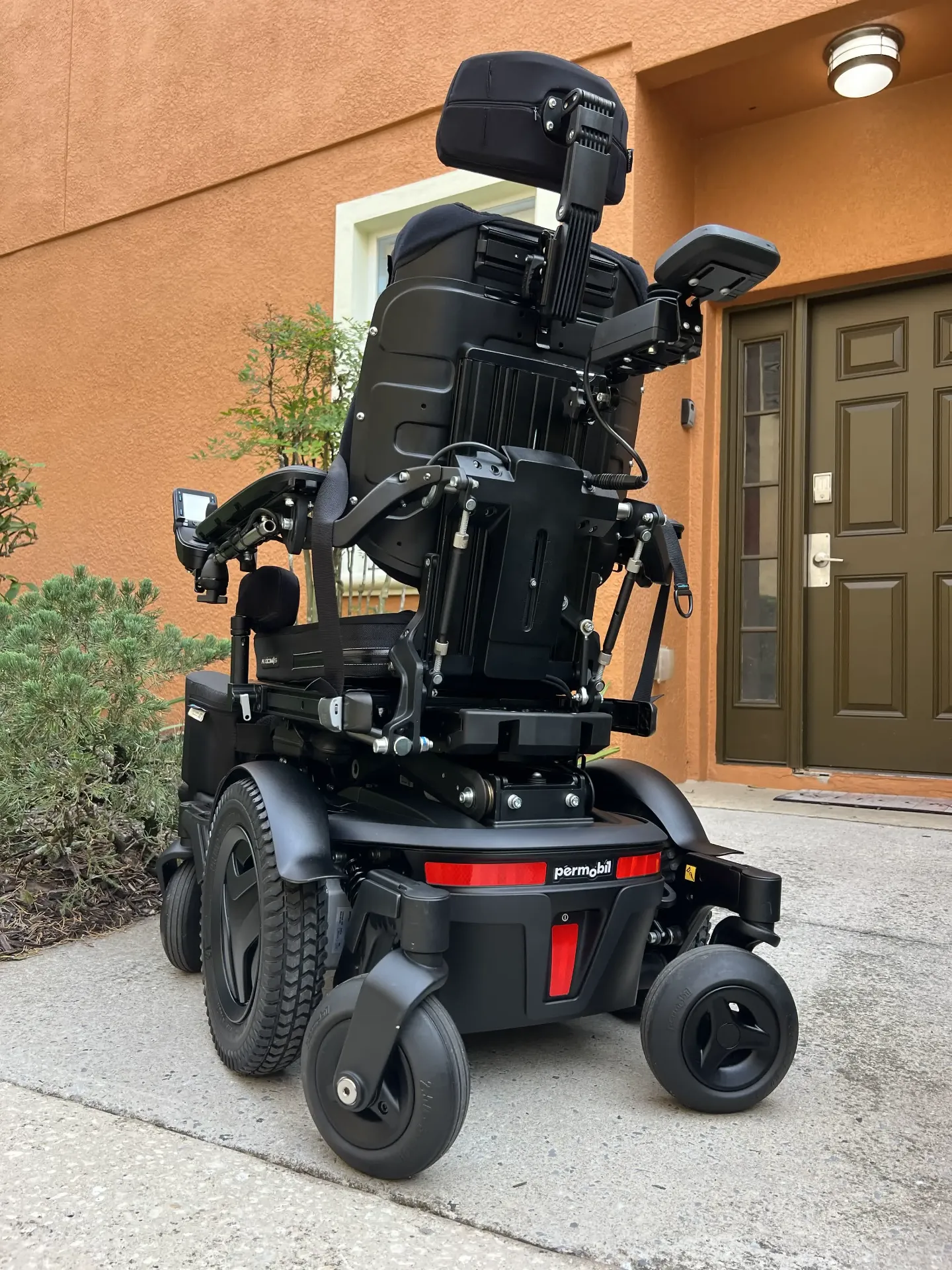 Permobil M3 Corpus power wheelchair front view with headrest and red accents